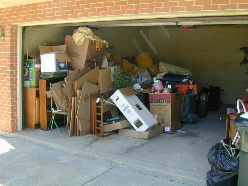 How can a junk removal service help when cleaning out your garage?